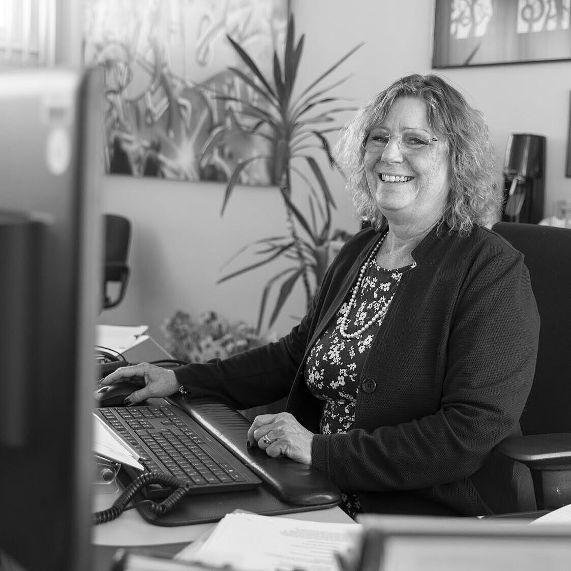 Porträt von Beate Brindle an ihrem Schreibtisch